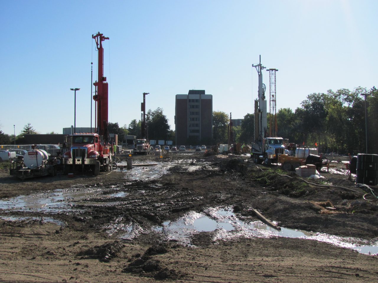 Road surface, Land lot, Sky, Building, Asphalt, Tire, Vehicle, Tree