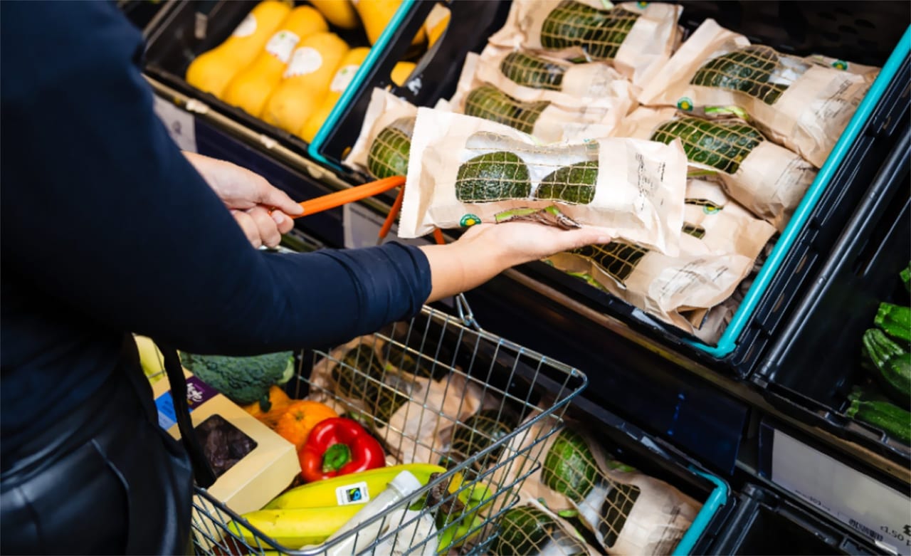Person grabbing Sainsbury’s avocados at the grocery store    
