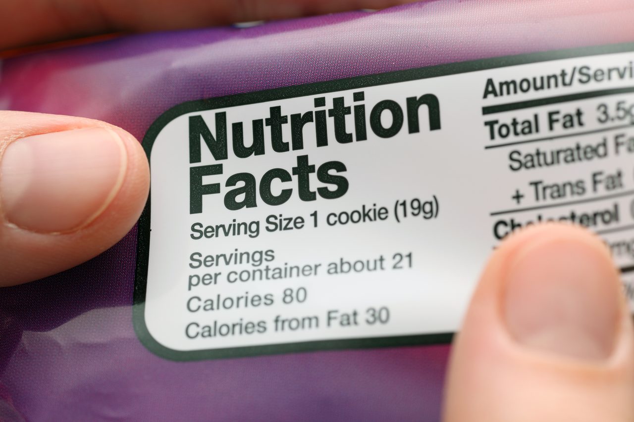 Reading a nutritional facts on cookies packaging