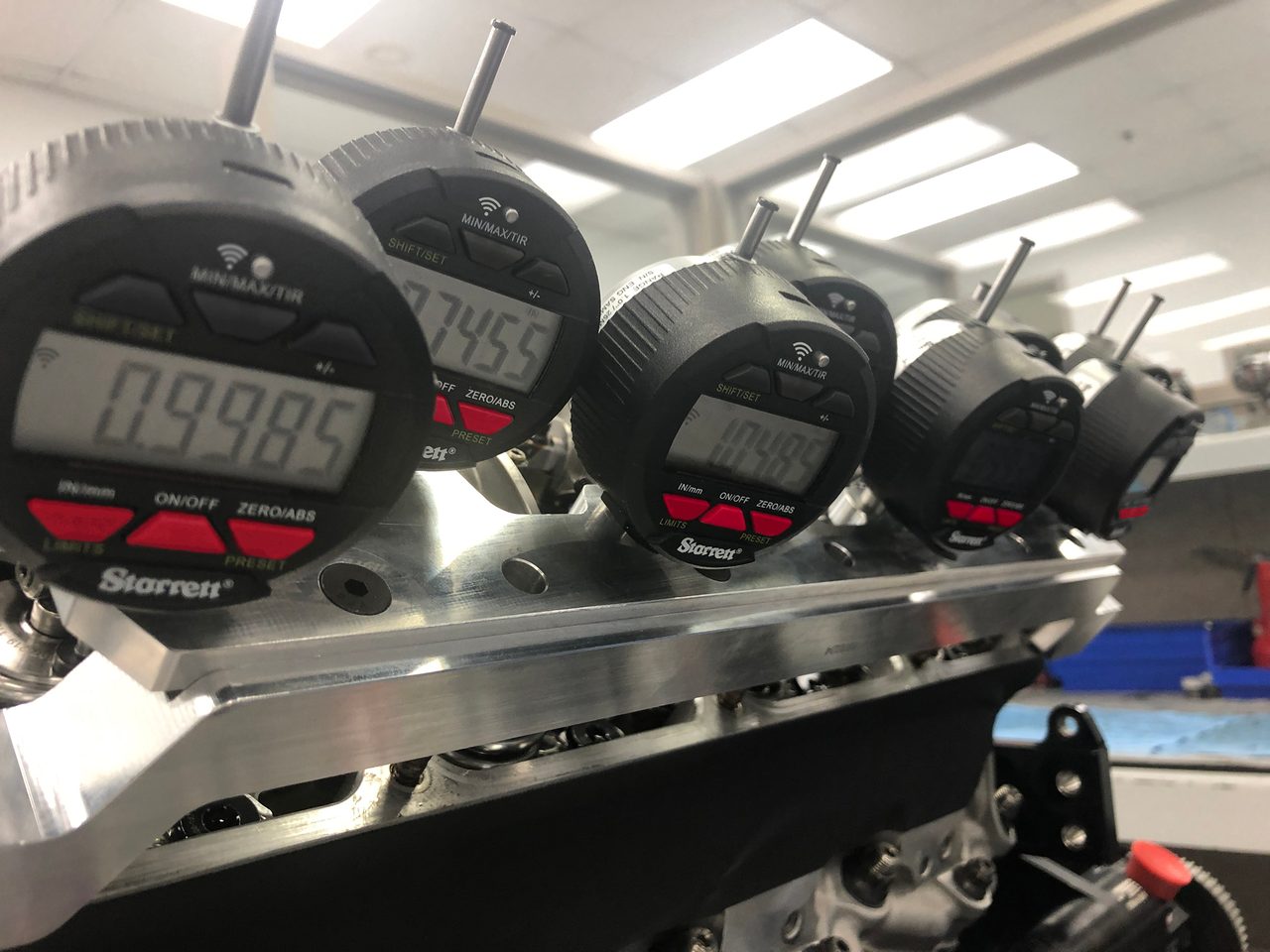 Multiple Starrett Wireless Indicators in engine-mounted fixture capture and transmit T.I.R. measurement data to computer devices