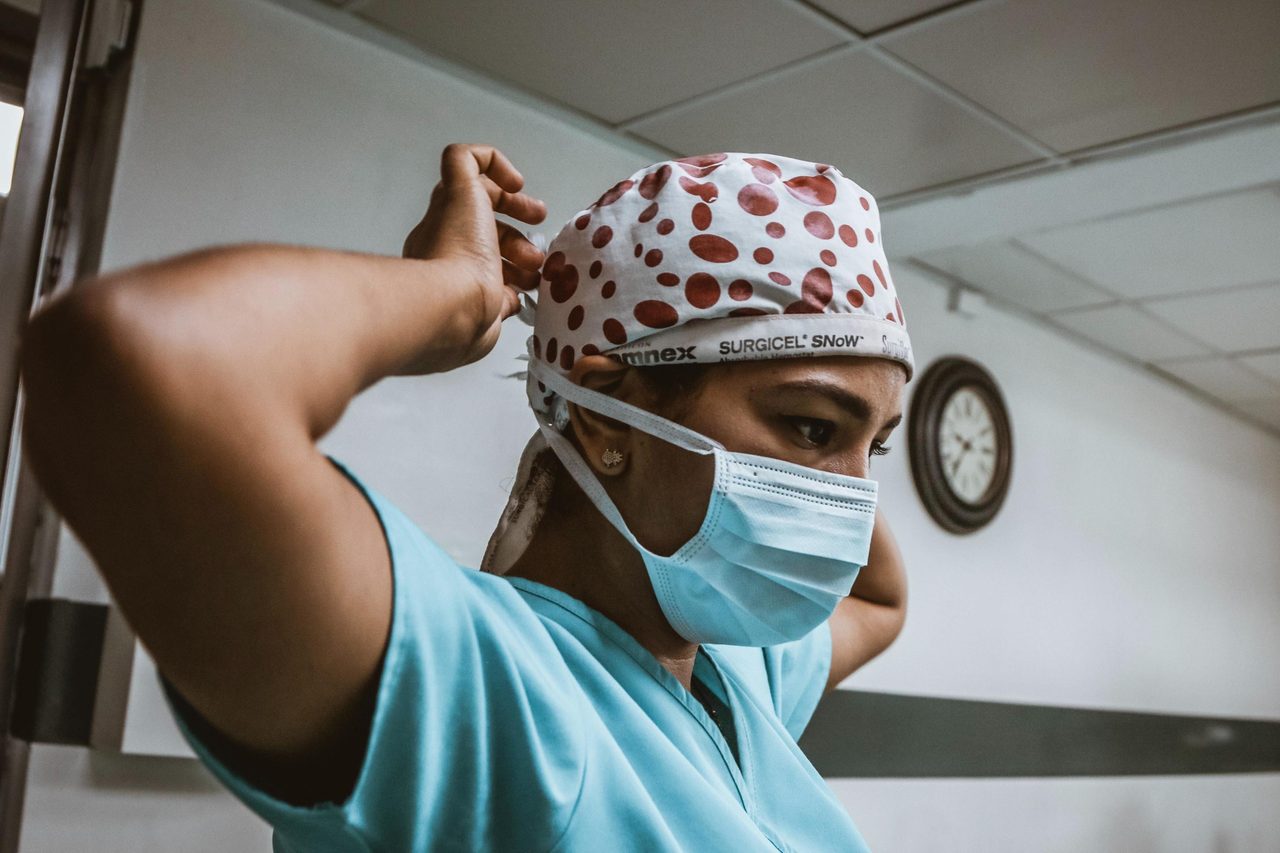 Health care provider, Mouth, Eyewear, Neck, Cap, Gesture, Eyelash, Clock, Headgear