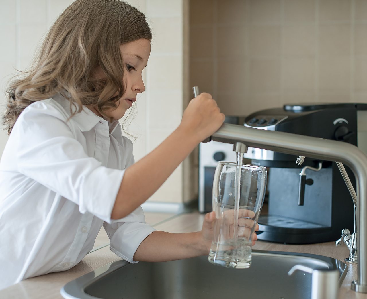 girl filling glass of water
