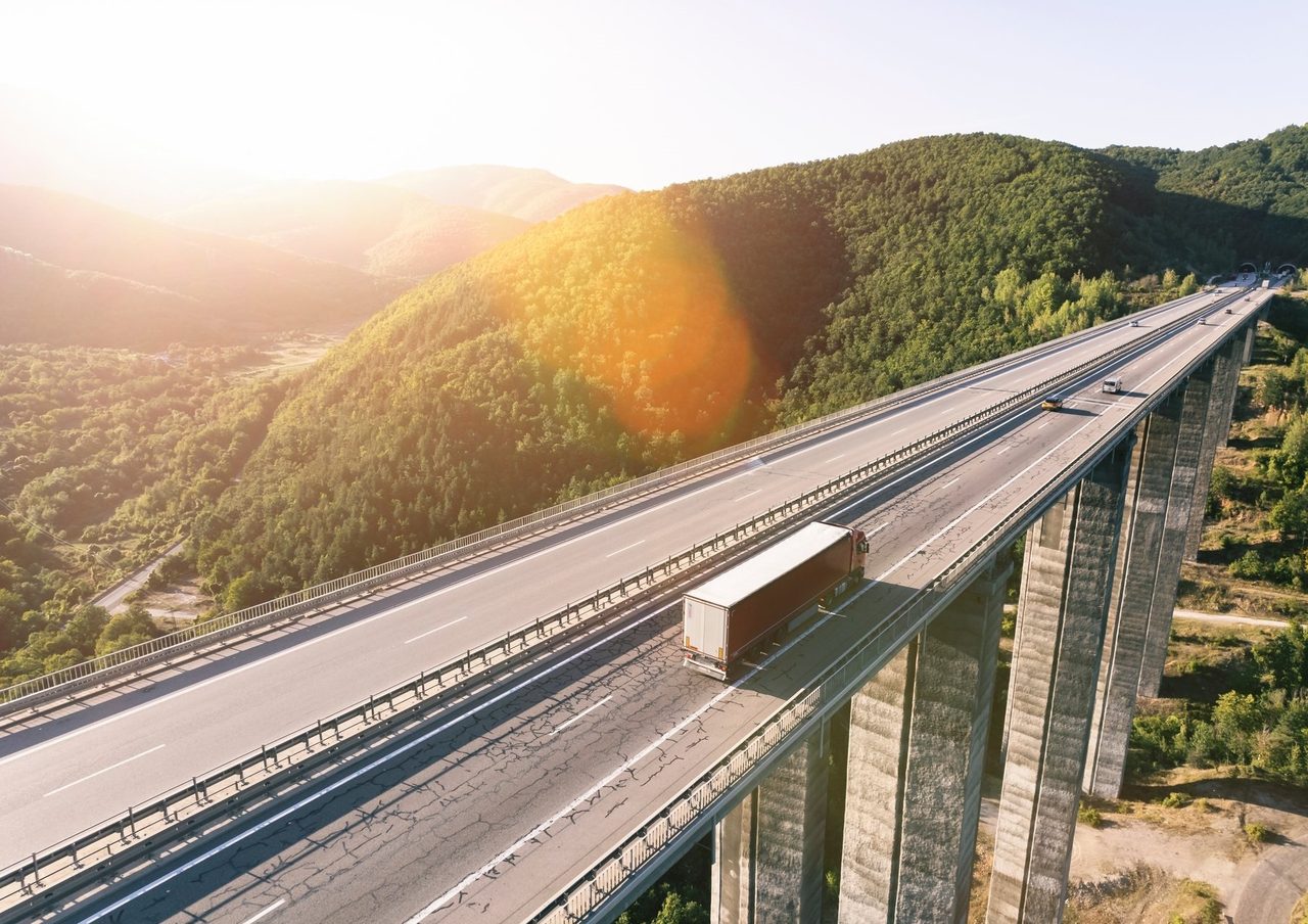 Mode of transport, Road surface, Natural landscape, Sky, Plant, Tree, Mountain, Line, Thoroughfare