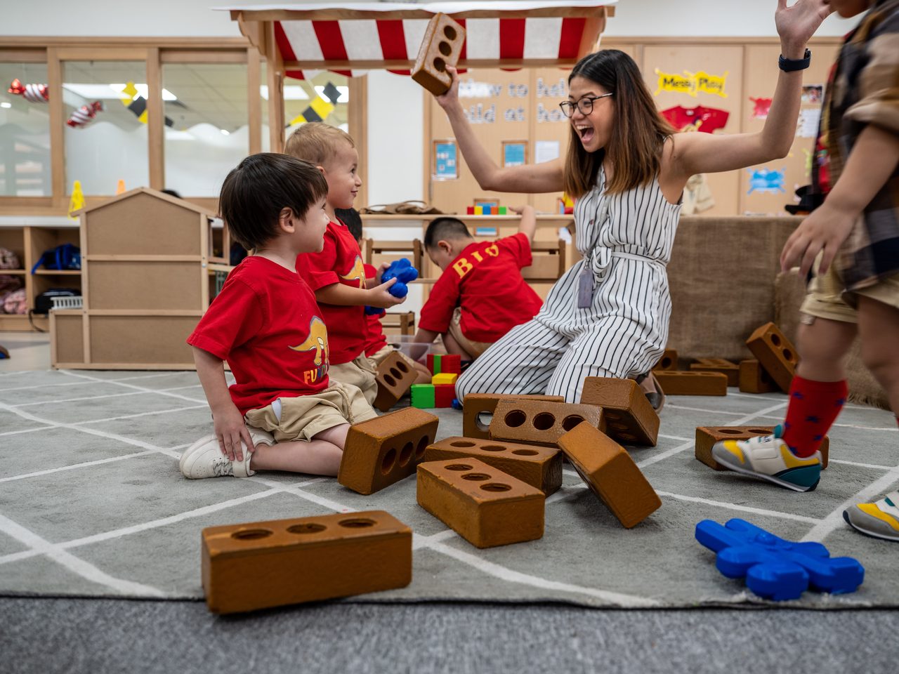 Shipping box, Social group, Public space, Shoe, Shorts, Wood, Leisure, Community, Toy, Fun