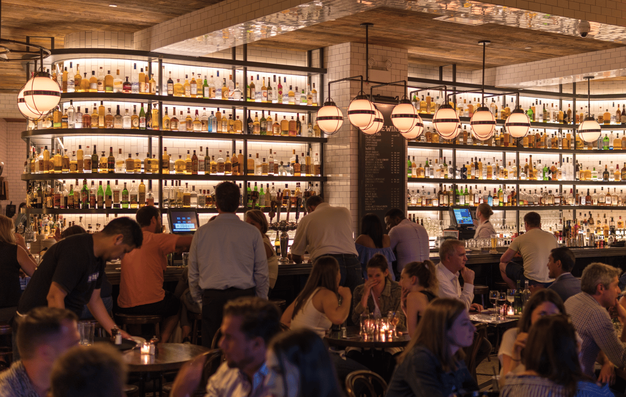 Drinking establishment, Photograph, Shirt, Shelf, Barware, Lighting, Building, Bottle, Customer, Shelving