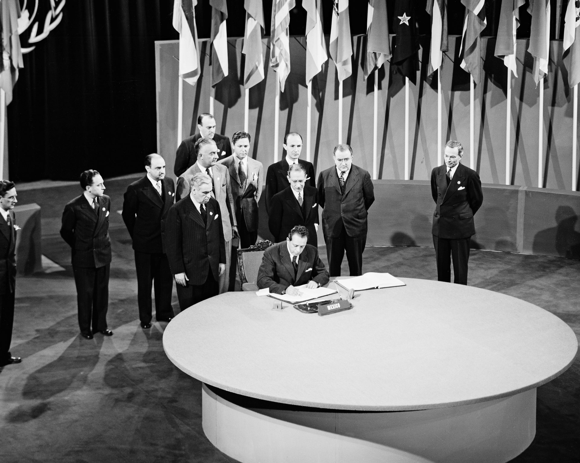 Photograph, White, Black, Standing, Coat, Black-and-white, Table, Style