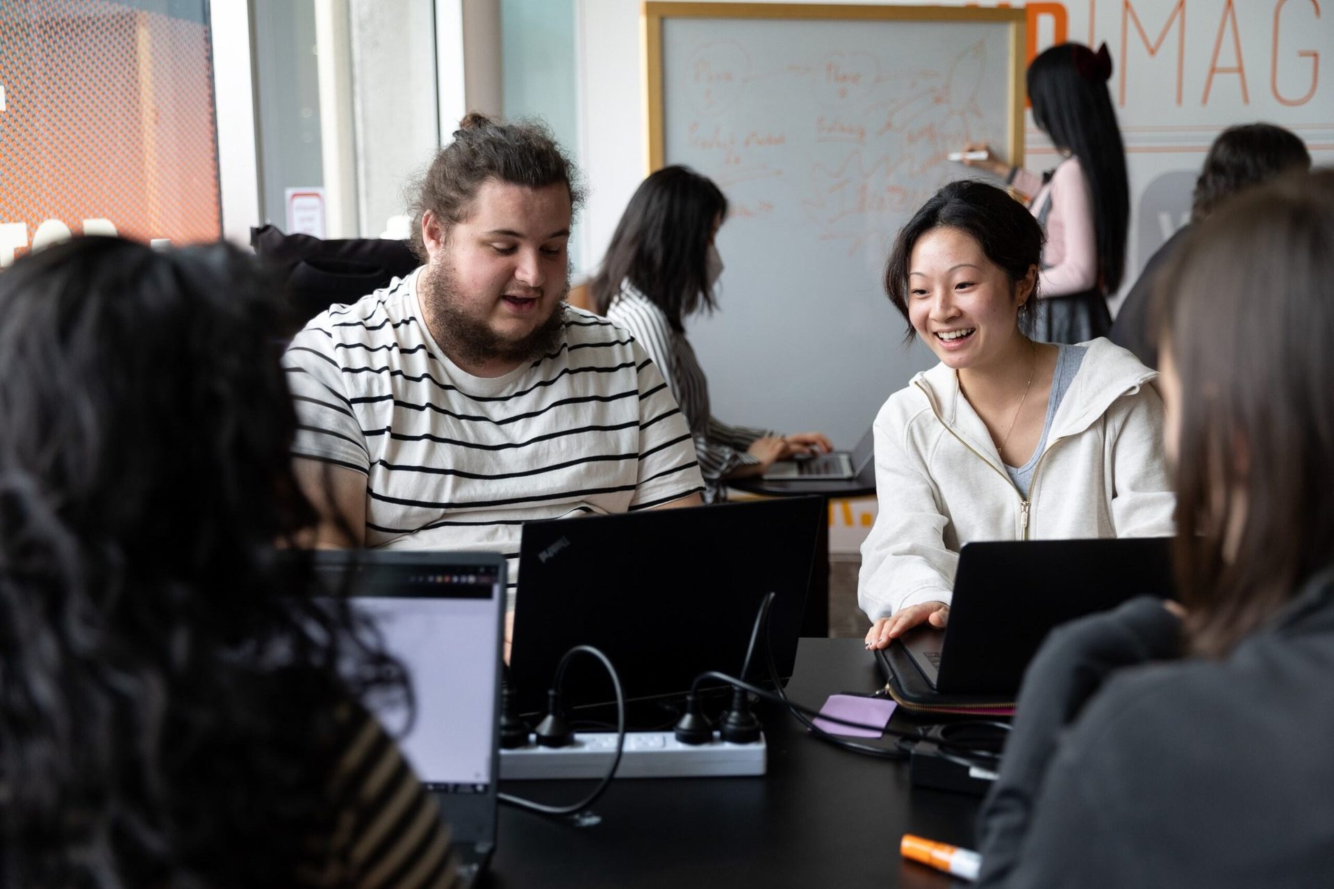 Personal computer, Social group, Laptop, Human, Window, Whiteboard, Interaction, Table, Smile