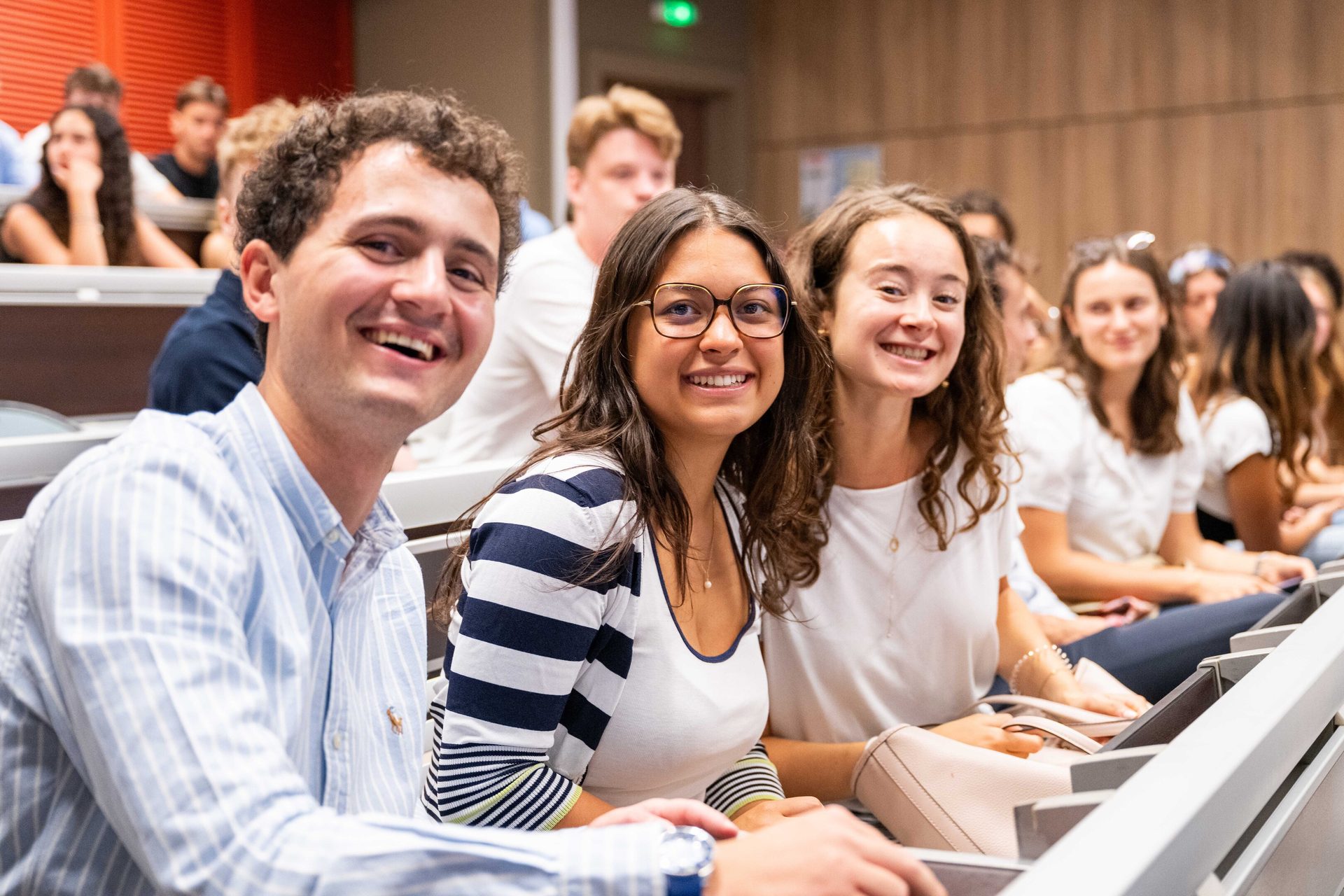 Students smiling in a classroom.