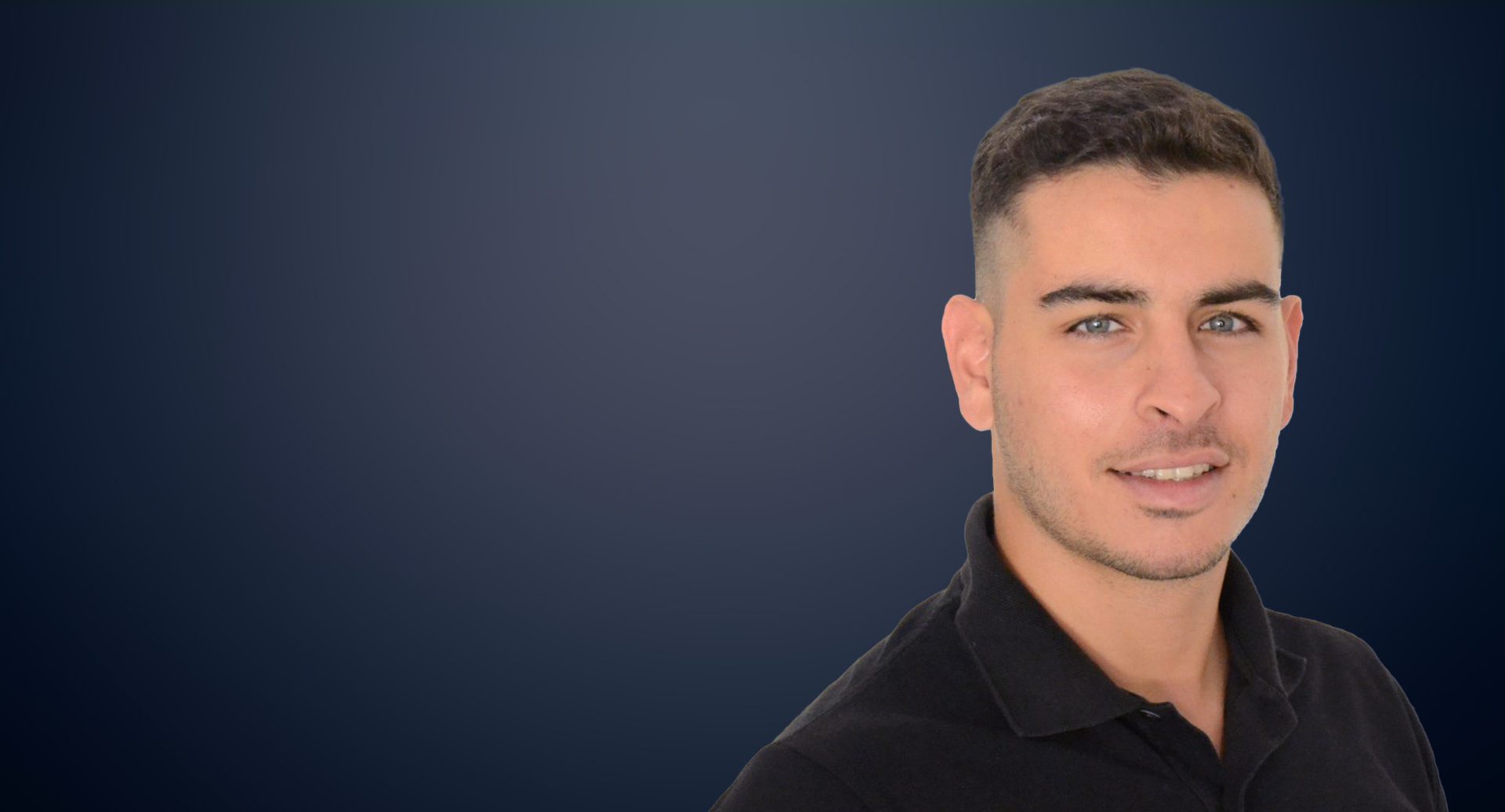 Smiling young man with short dark hair and light eyes in a black polo shirt.