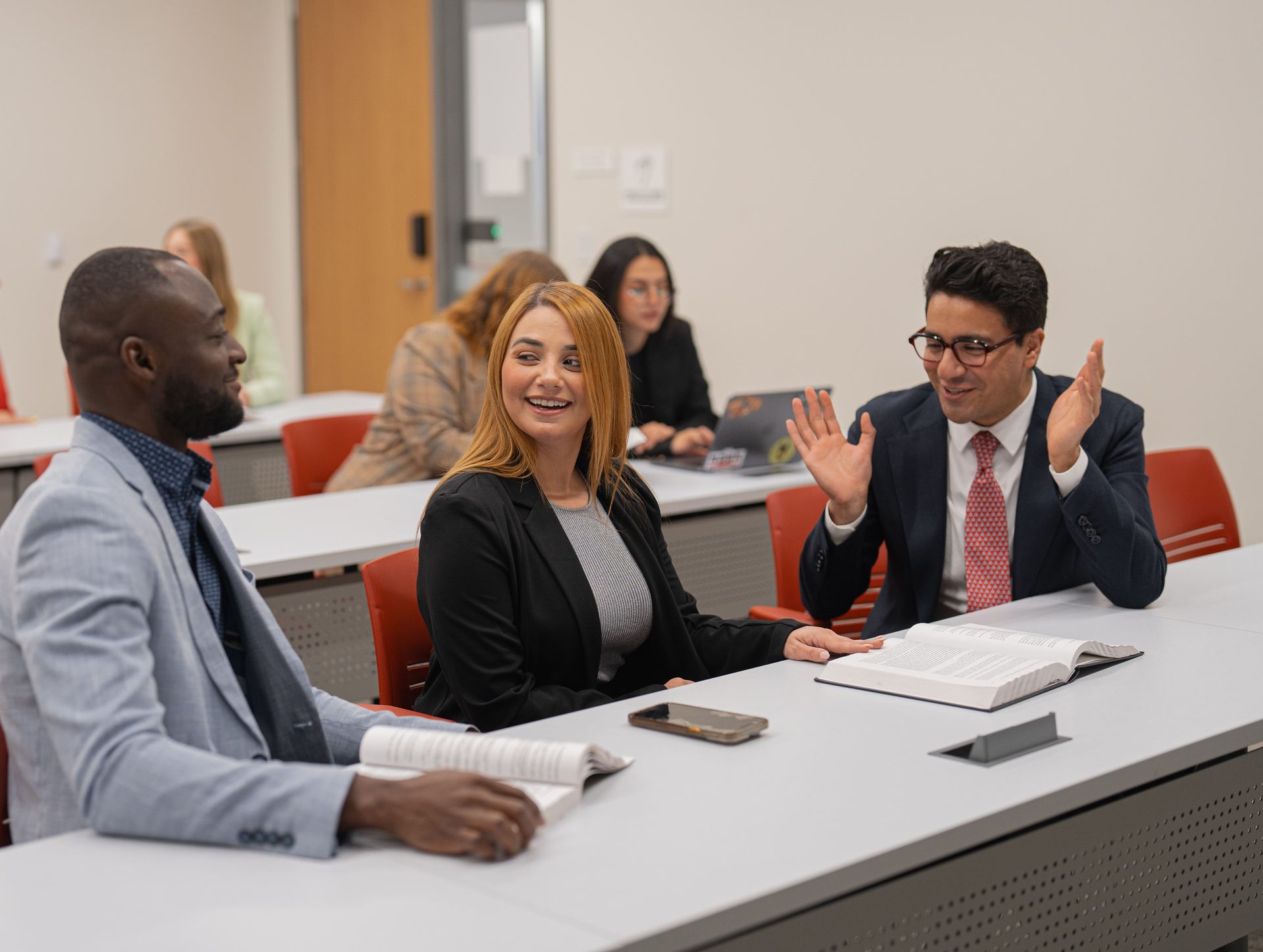 Interior design, Social group, People, Furniture, Table, Outerwear, Desk, Meeting, Interaction, Chair