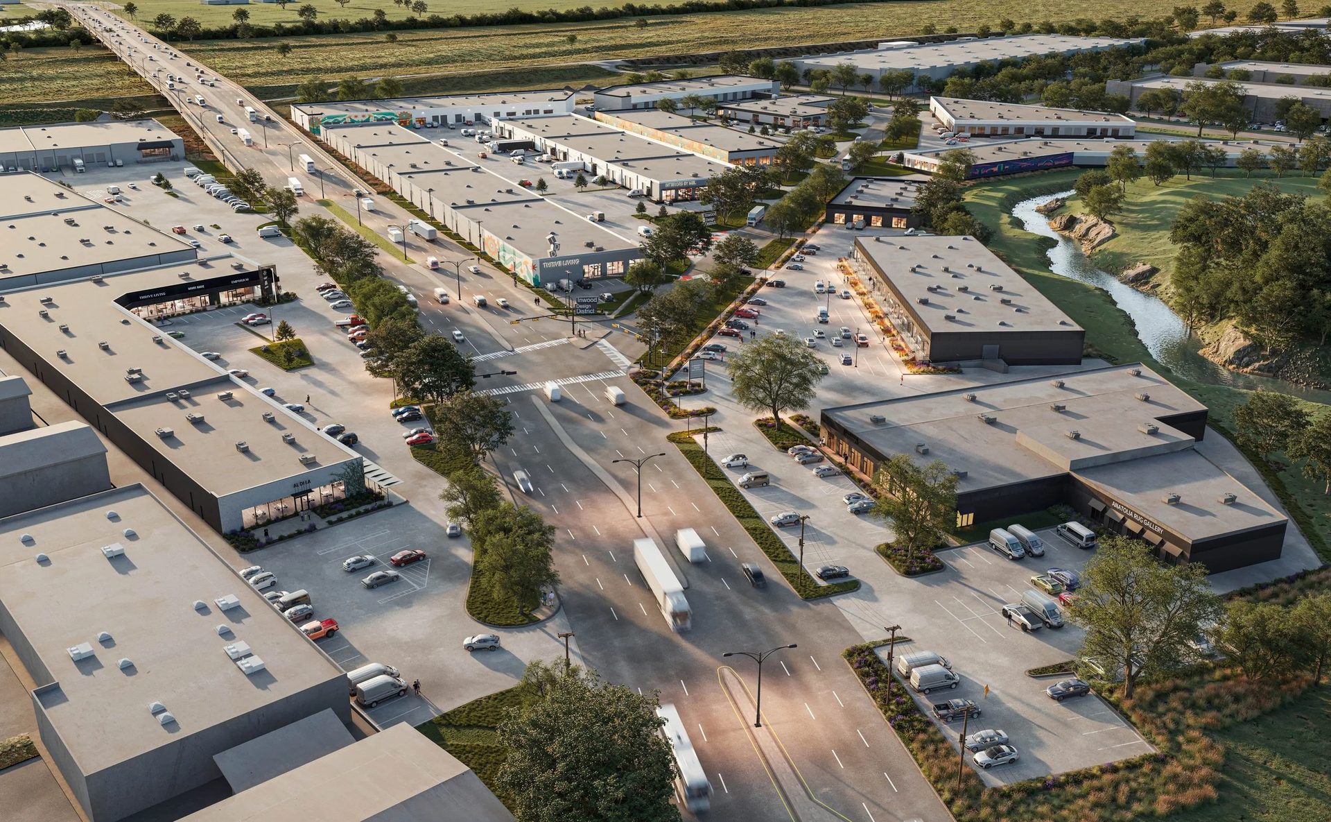 Aerial view: bustling commercial district with warehouses, roads, cars, trucks, and a winding river.