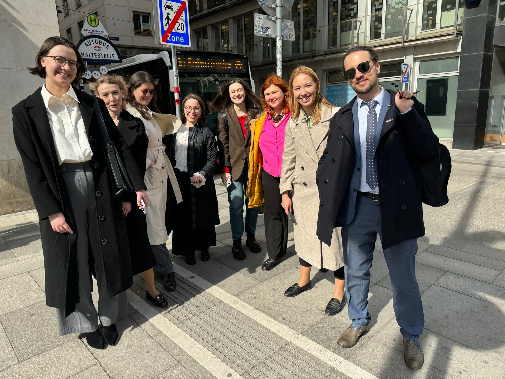People, Smile, Sleeve, Outerwear, Collar, Trousers, Shoe, Standing, Bag, Coat