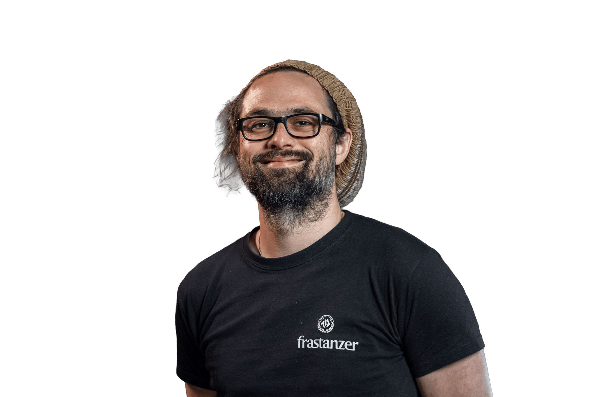 A smiling man with glasses, a beard, and a beanie hat looks at the camera.