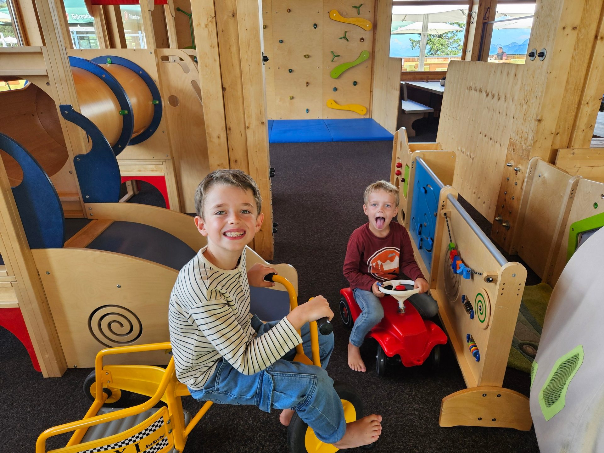 Two boys playing inside.