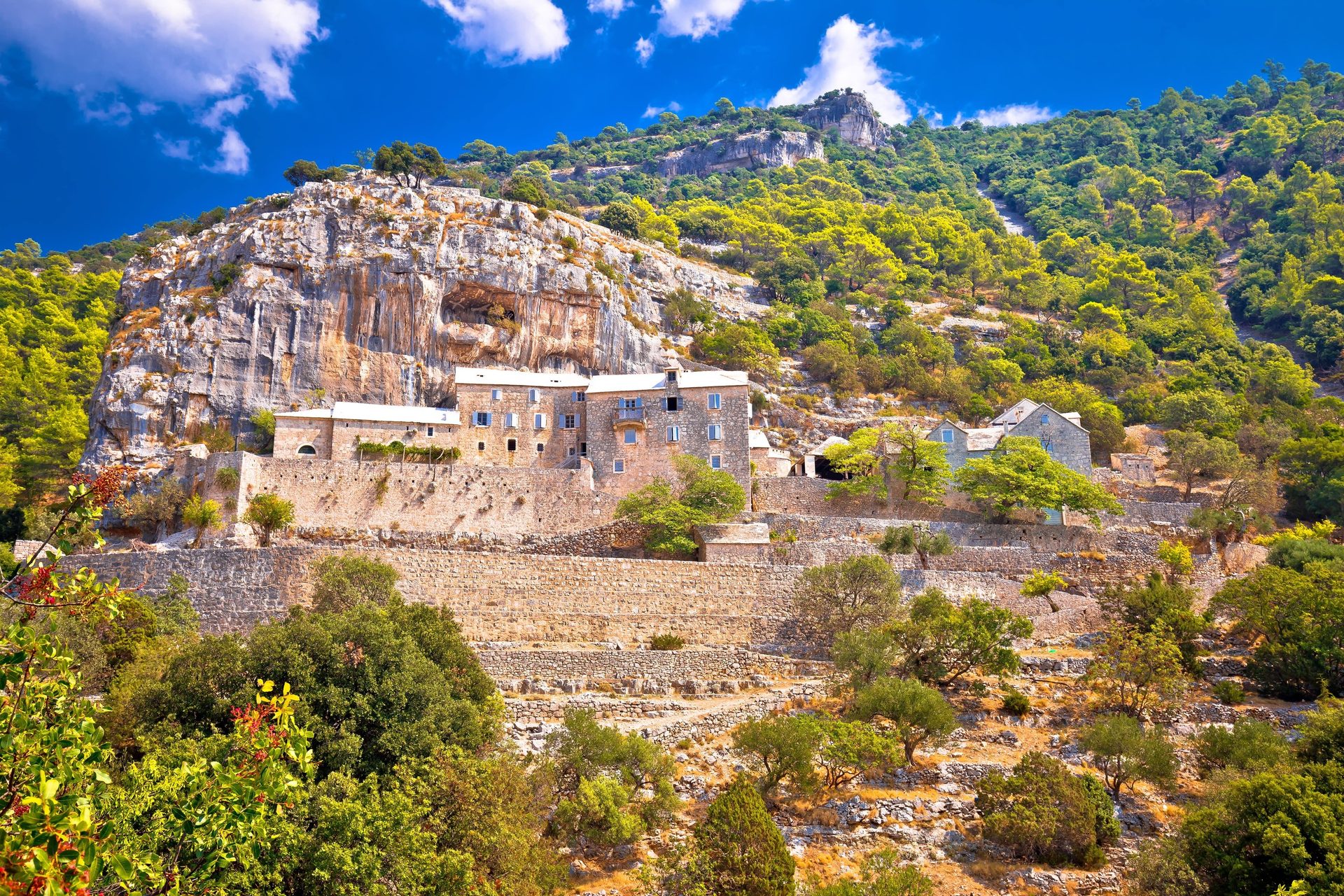 Rural area, Human settlement, Geological formation, Wall, Mountain, Landscape, Rock, Terrain, Village