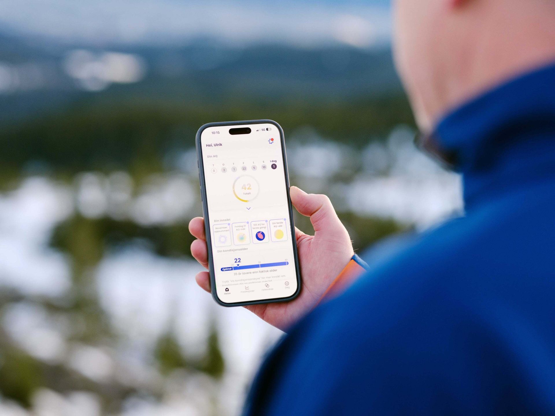 Person outdoors holding a smartphone with a health app showing a fitness age of 22 and an AQ score.