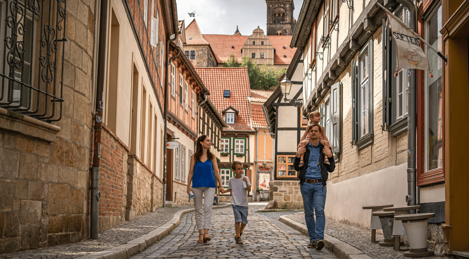 Road surface, Jeans, Window, Building, Infrastructure, Sky, House, Wood, Sunlight, Flooring