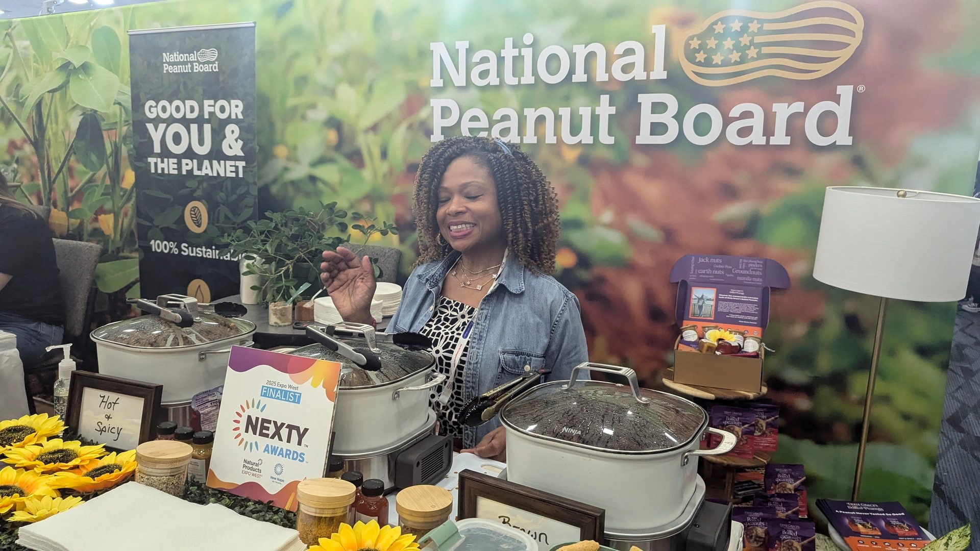 Woman at National Peanut Board booth promoting sustainable peanuts and products.