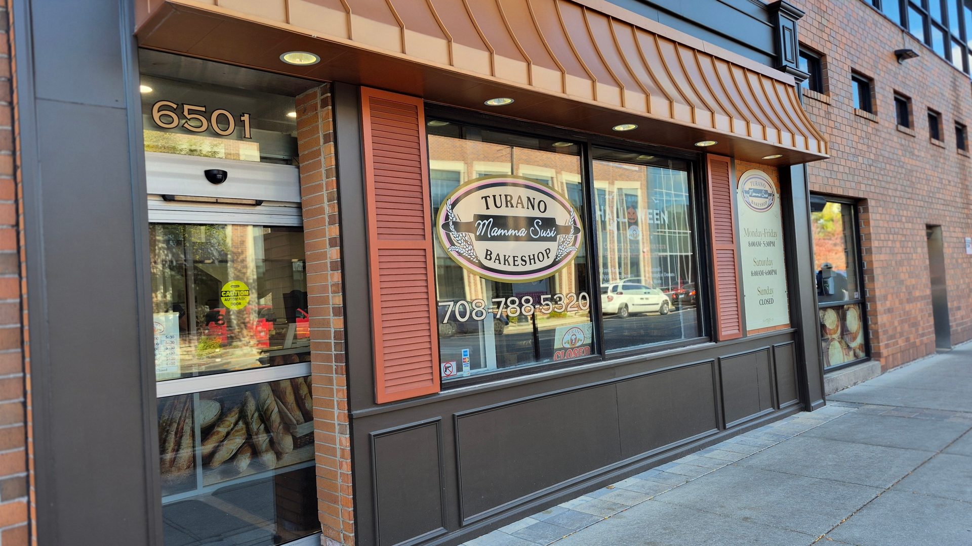 Exterior of Turano Mamma Susi Bakeshop at 6501, with its logo, phone (708-788-5320), and hours displayed.