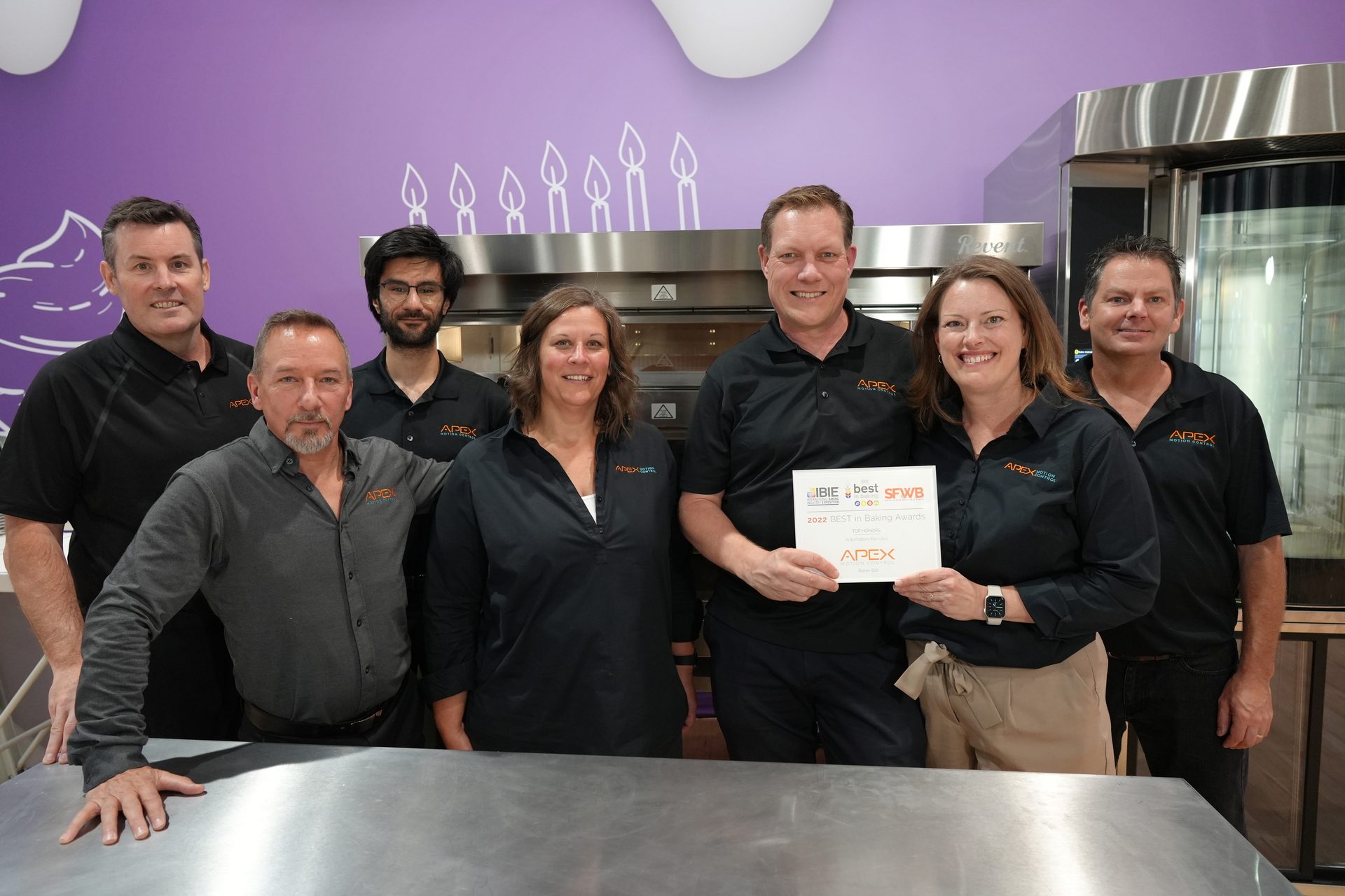 Group photo, Smiles, Show booth, Award, Button-up shirts, Stainless steel countertop