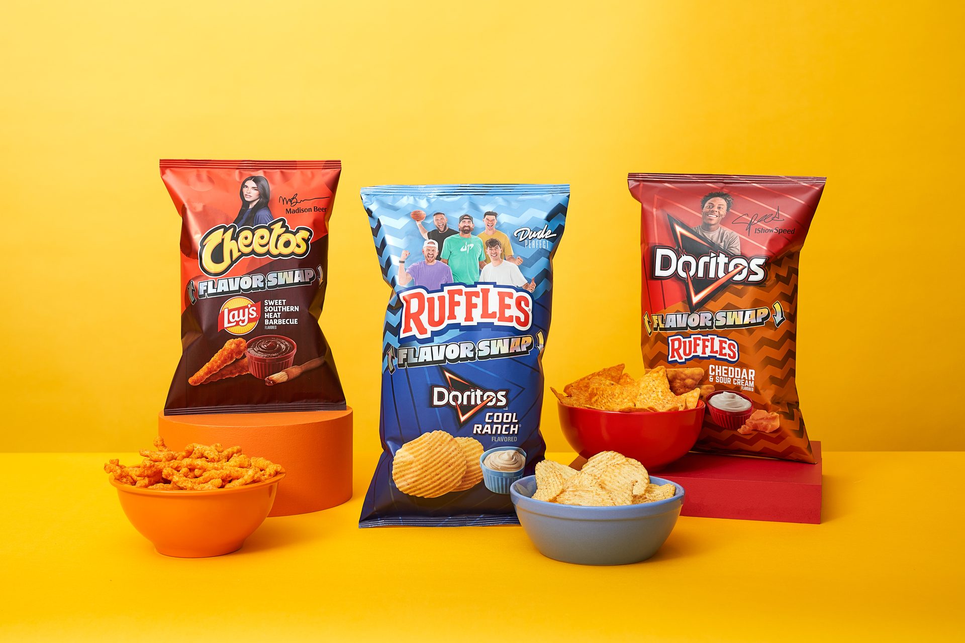 Three bags of 'Flavor Swap' chips (Cheetos, Ruffles, Doritos) with bowls of snacks.