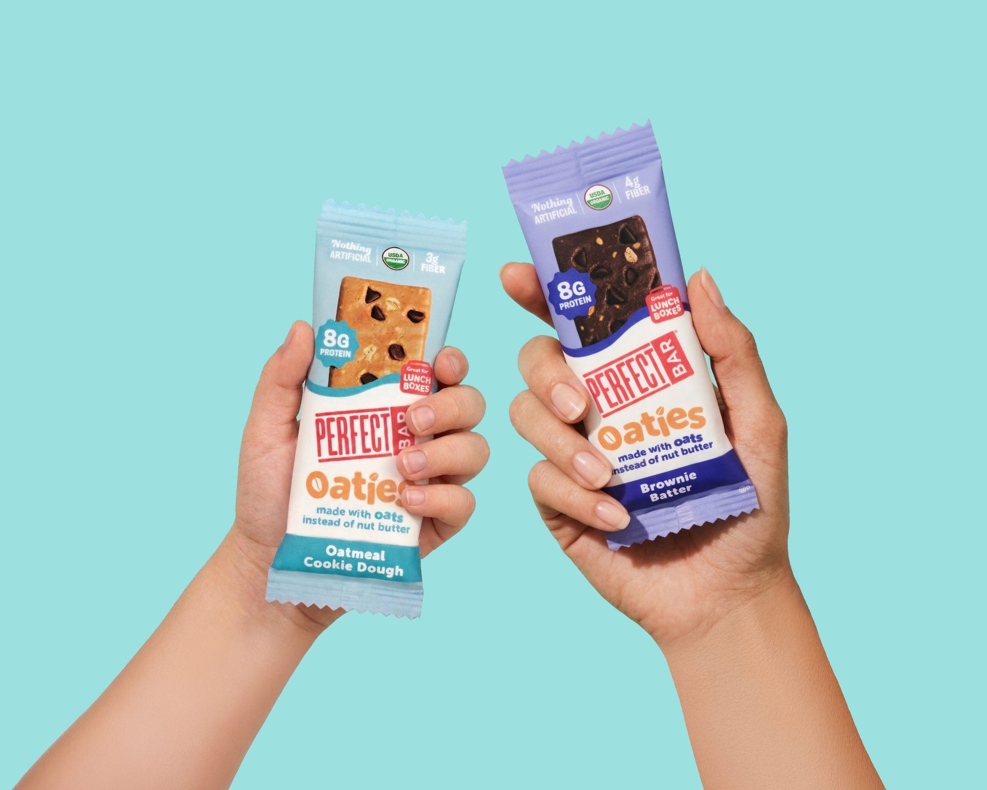 Two hands hold Perfect Oaties snack bars in Oatmeal Cookie Dough and Brownie Batter flavors.