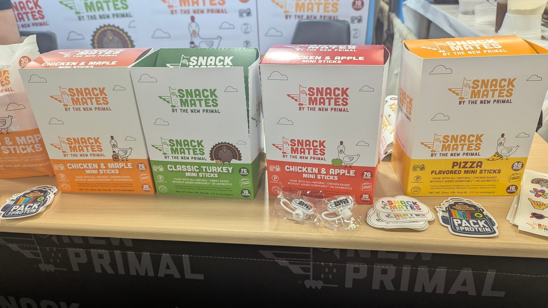 Boxes of "Snack Mates by The New Primal" mini sticks in assorted flavors.