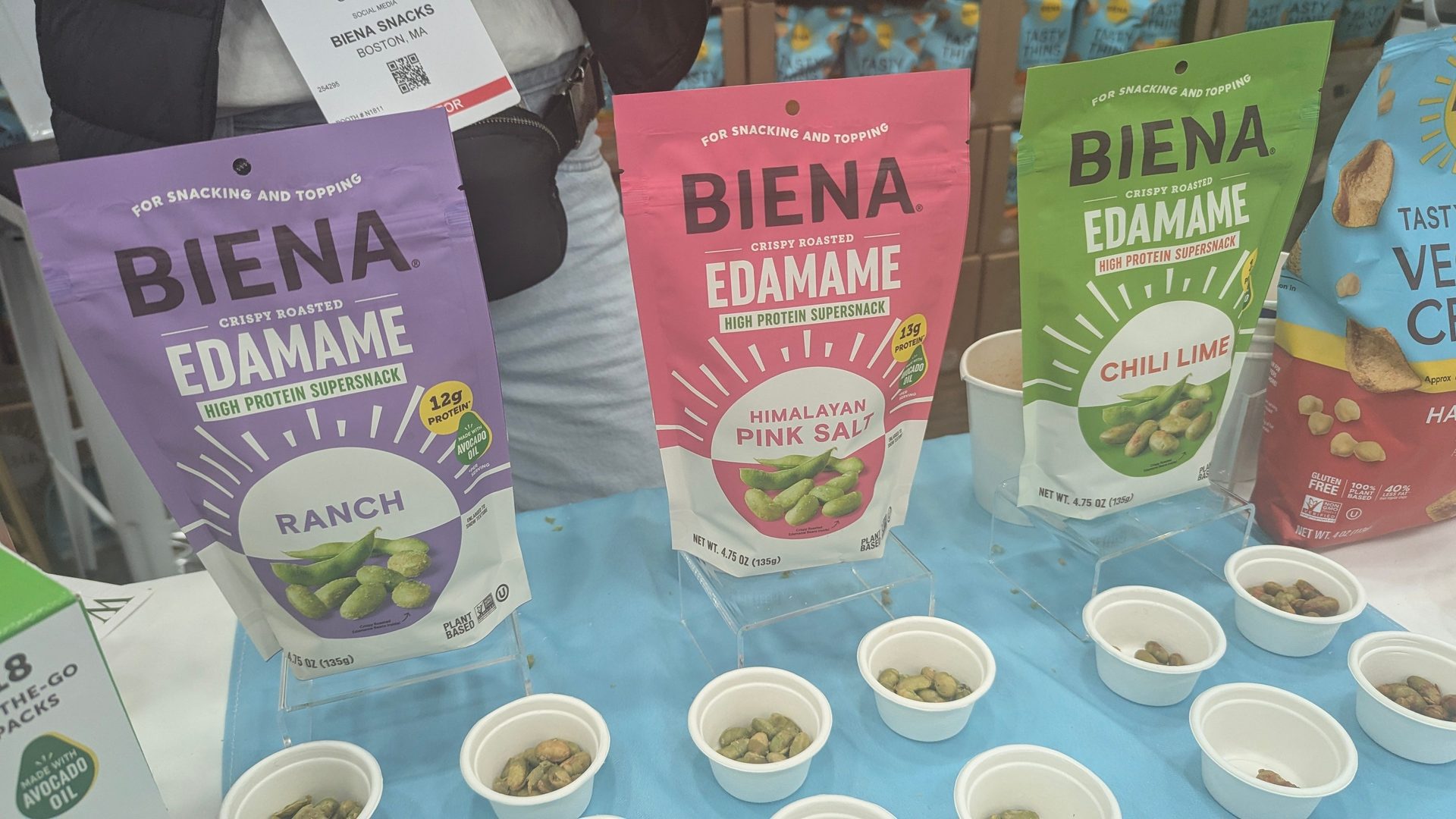 Bags of Biena Crispy Roasted Edamame (Ranch, Himalayan Pink Salt, Chili Lime) with samples.