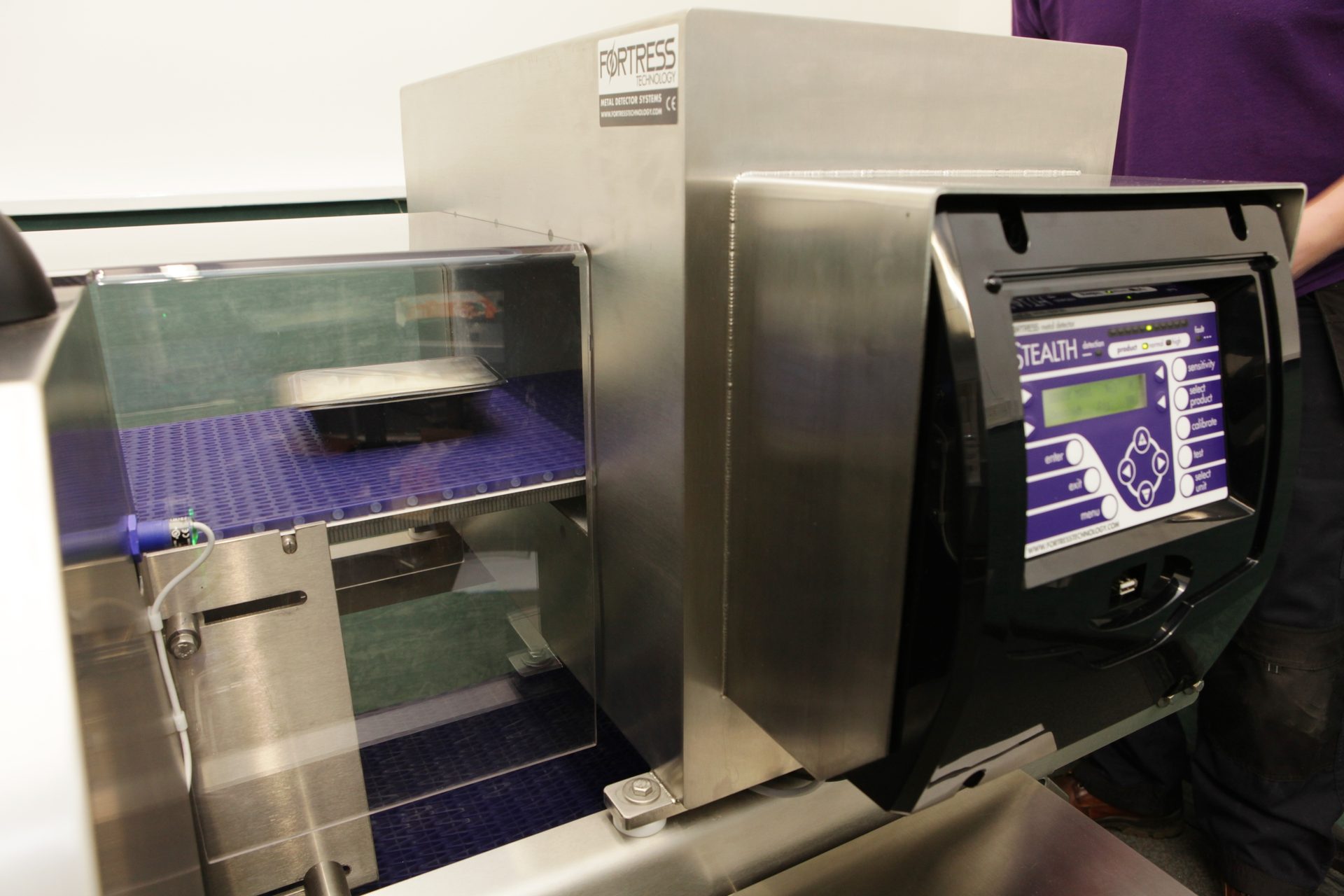 Fortress Technology metal detector with conveyor, product, and control panel.