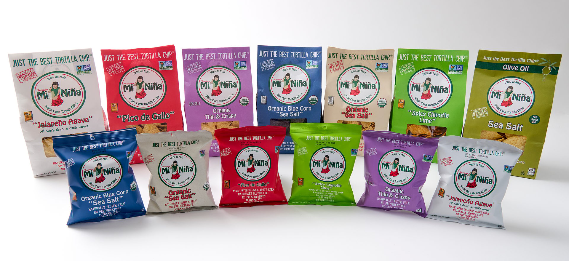 A variety of Mi Niña tortilla chip bags in different flavors and sizes on a white background.