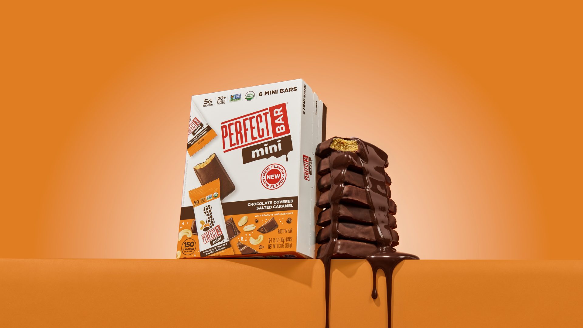 Perfect Bar Mini box, chocolate-covered salted caramel bars stacked with dripping chocolate, on orange.