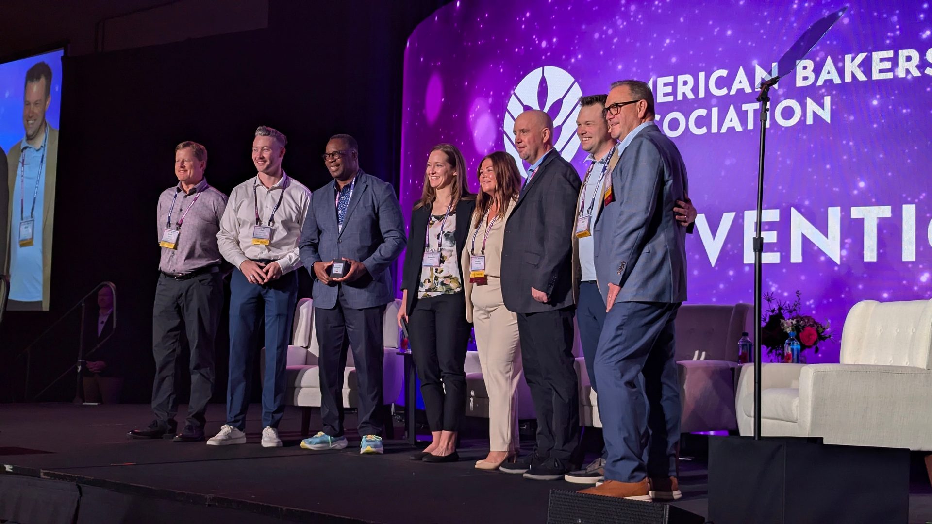 six people standing on the American Bakers Association stage