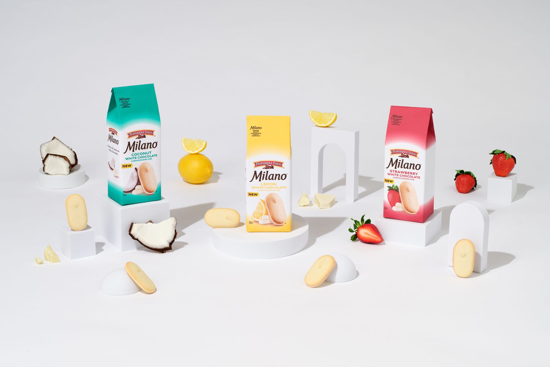 The full lineup of Milano White Chocolate fruit flavors, in green, yellow, and red packaging.