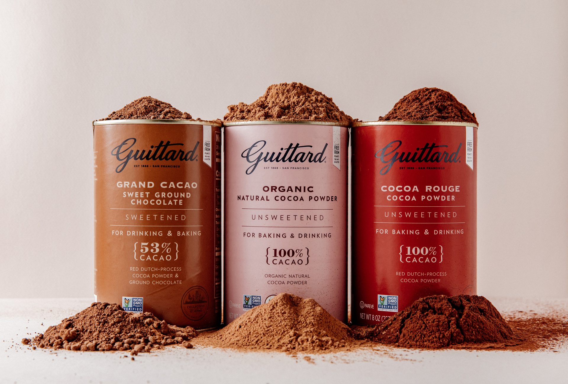 Three tins of Guittard Chocolate cocoa powder