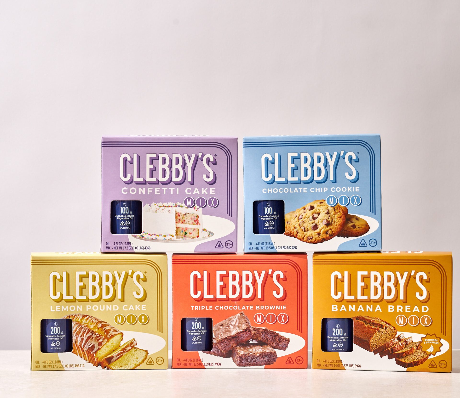Five colorful Clebby's baking mix boxes for cannabis-infused cake, cookies, brownies, and bread.
