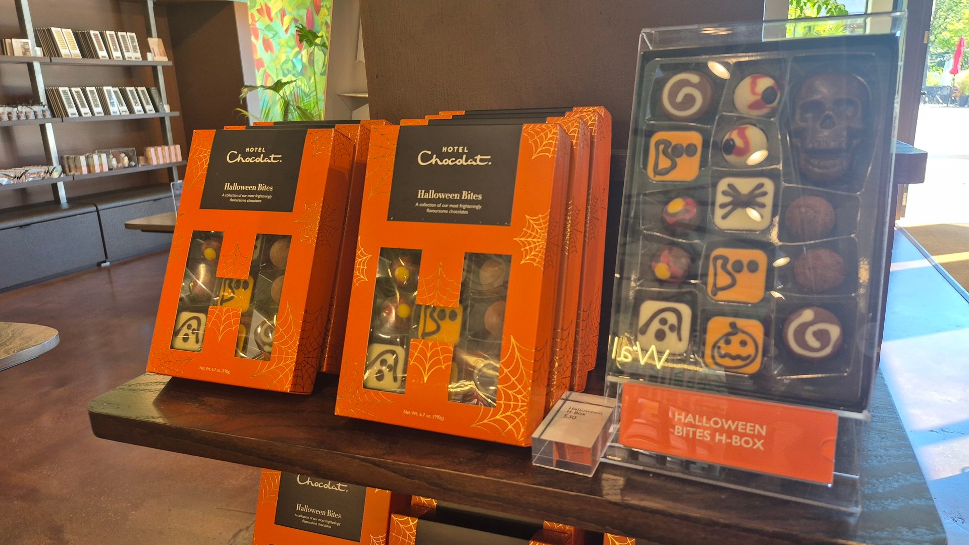 Hotel Chocolat Halloween Bites display: orange boxes, skull, eyeballs, ghosts, and pumpkin chocolates.