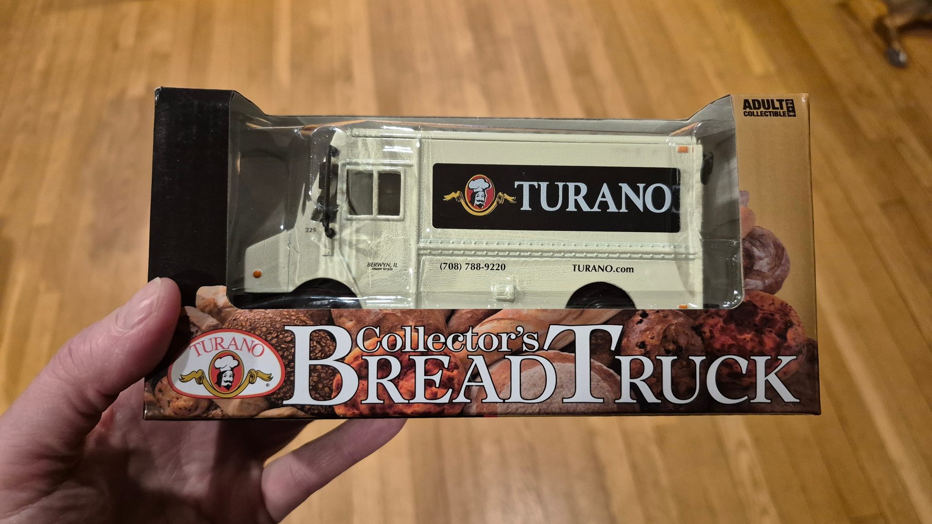Hand holding a packaged Turano Collector's Bread Truck, an adult collectible toy.