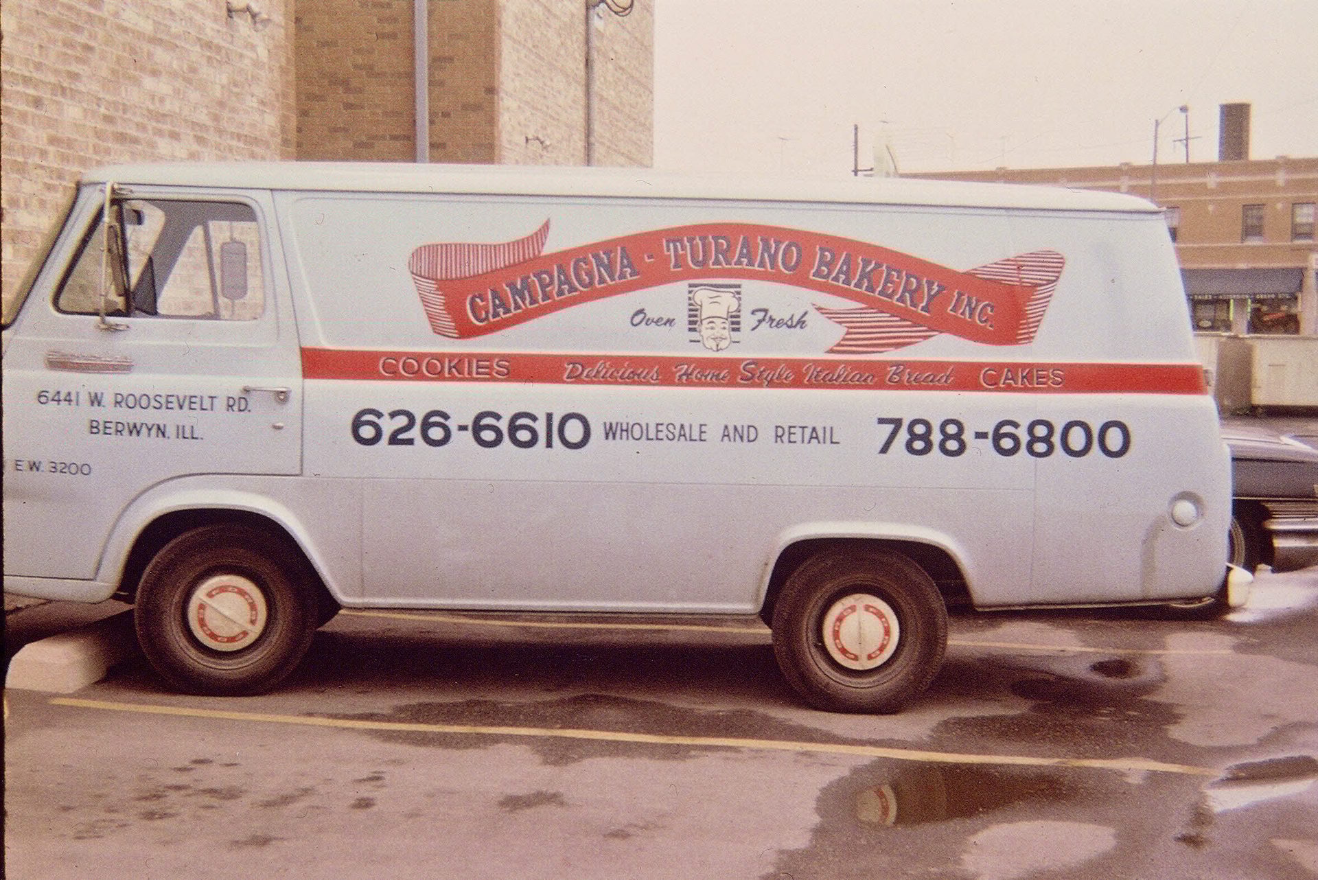 A vintage white Campagna-Turano Bakery delivery van with products, address, and phone numbers.
