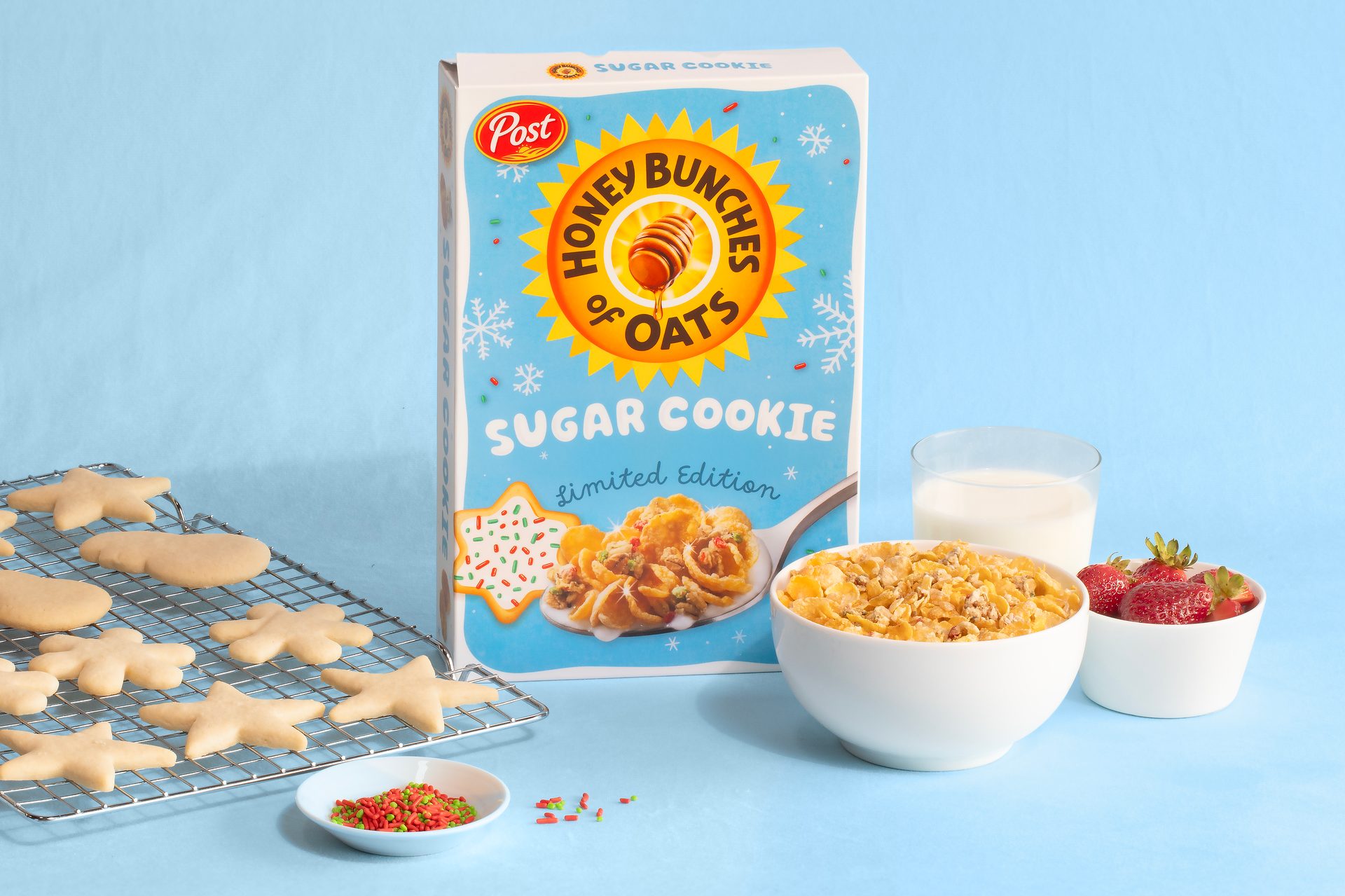 Honey Bunches of Oats Sugar Cookie cereal box, cereal, milk, strawberries, and unbaked cookies.