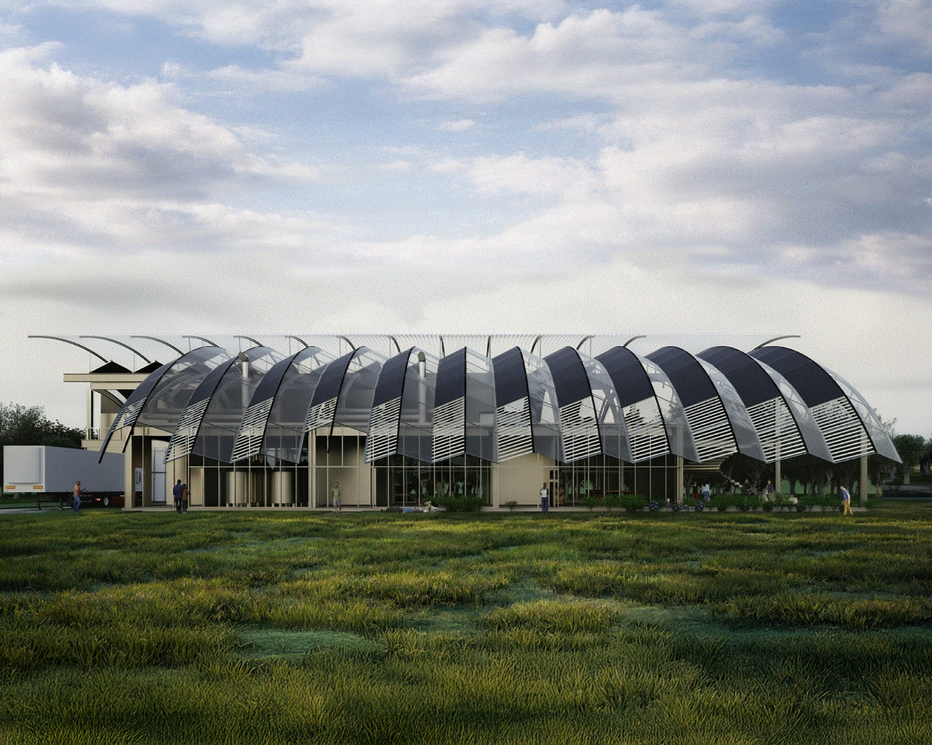 Modern building with a distinctive curved, segmented glass and panel facade, set in a grassy landscape.