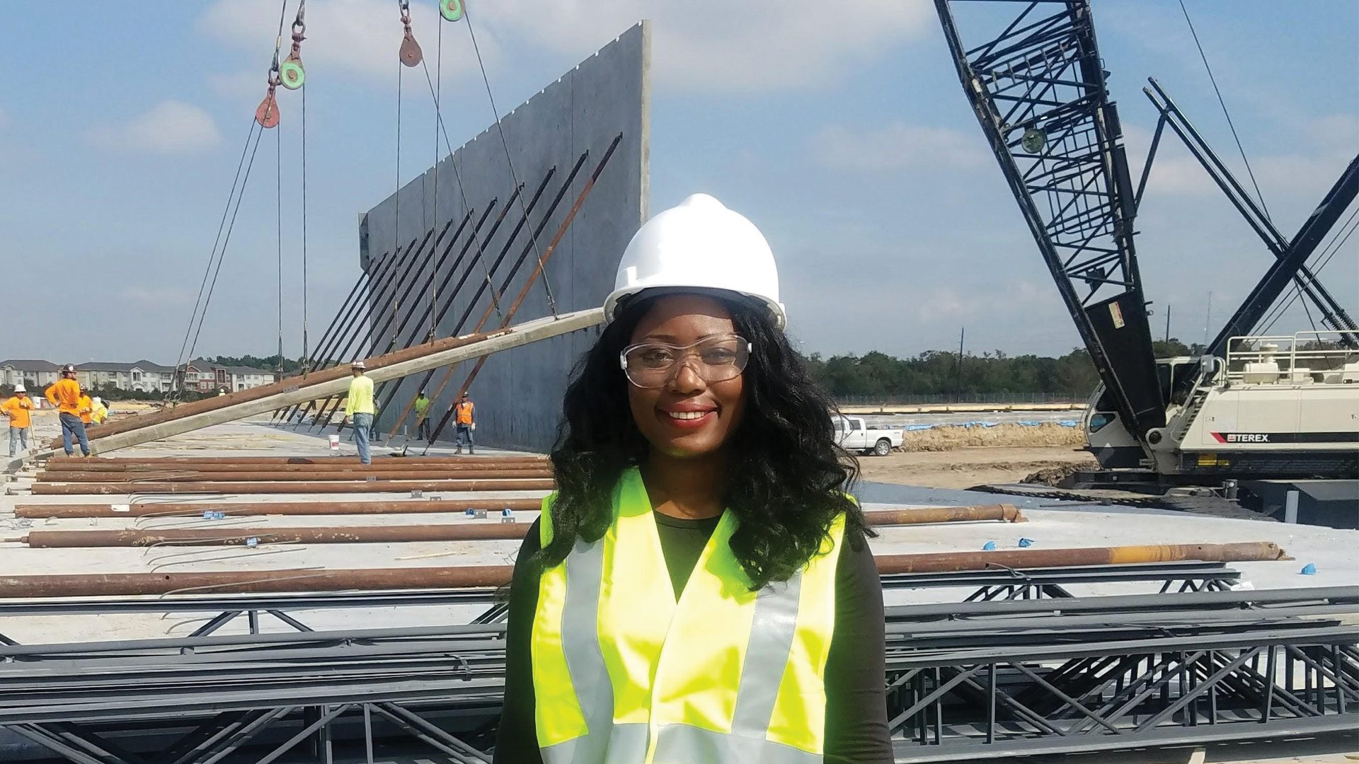 Hard hat, High-visibility clothing, Glasses, Sky, Cloud, Smile, Infrastructure, Sleeve, Goggles, Sunglasses