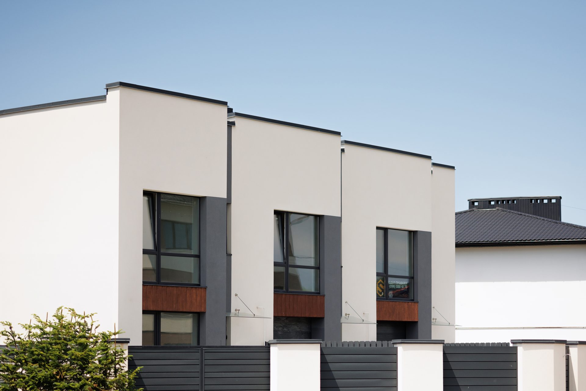Urban design, Residential area, Property, Building, Window, Sky, Rectangle, Fixture, Plant, Wall