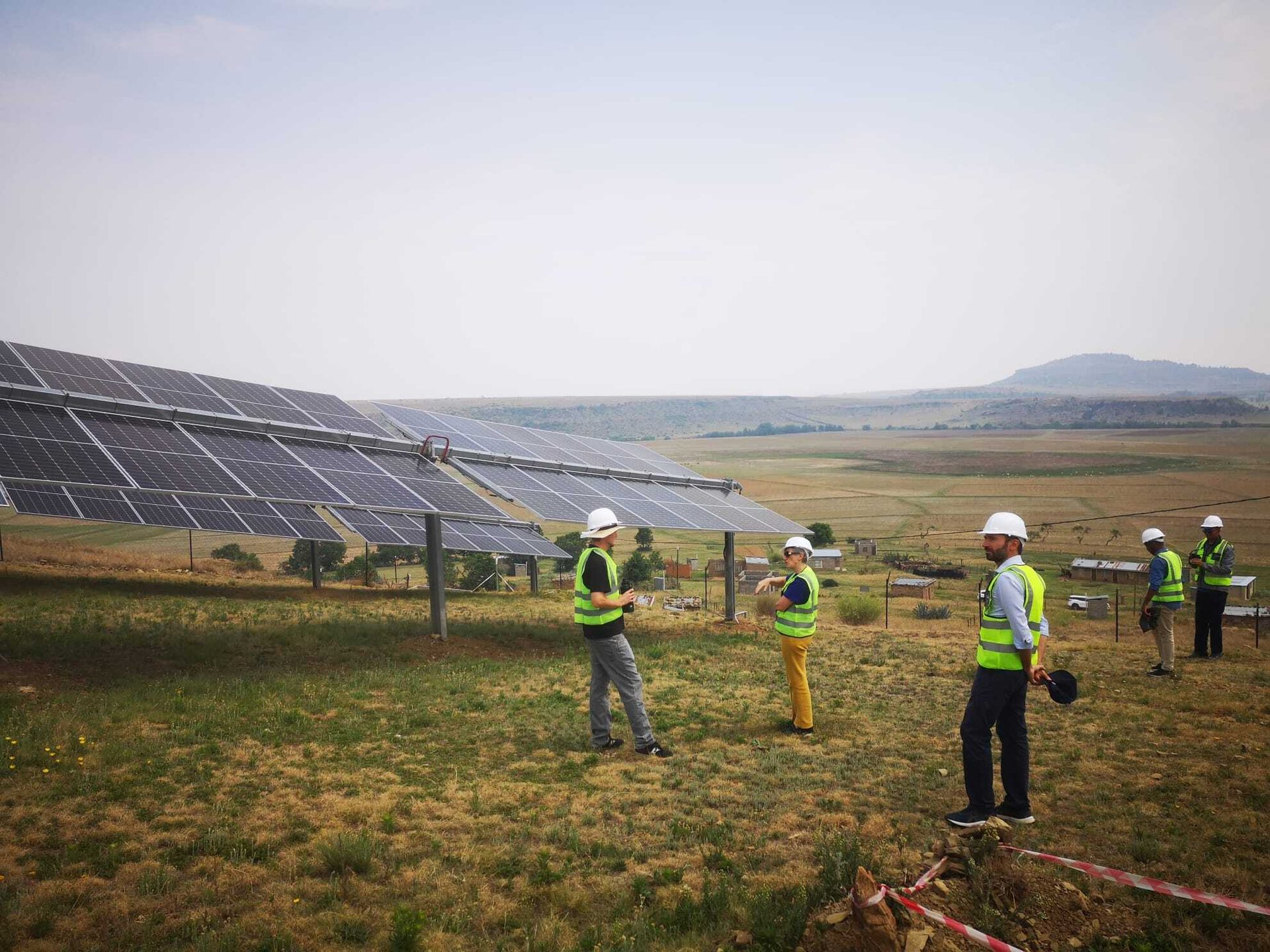 Solar panel field inspection with workers.