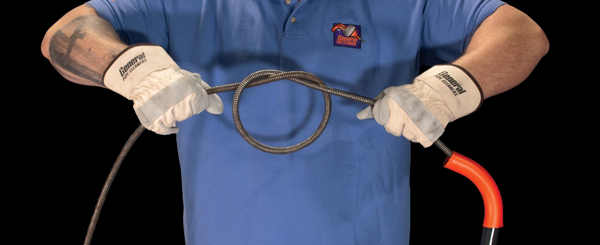 Person in blue shirt and General Pipe Cleaners gloves holding a knotted drain snake.