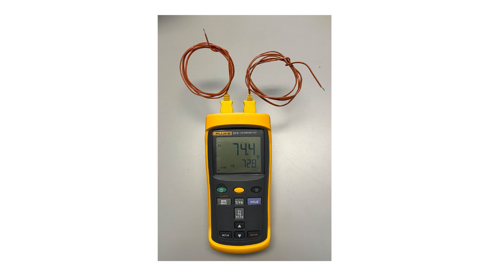 A Fluke 52 II thermometer with two thermocouples displaying 74.4°F and 72.8°F.