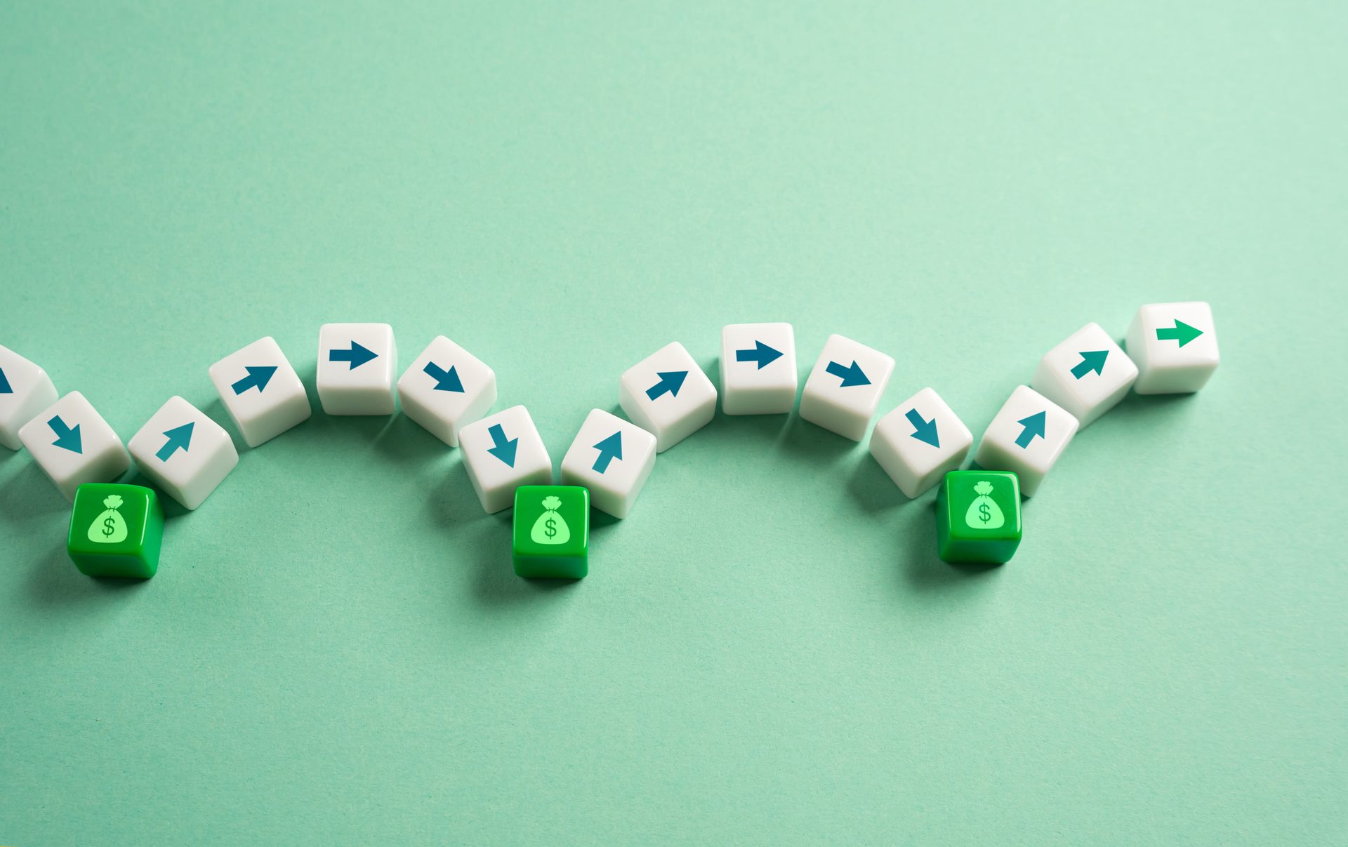 A wavy line of white arrow blocks and green money bag blocks on a green background, symbolizing financial flow.