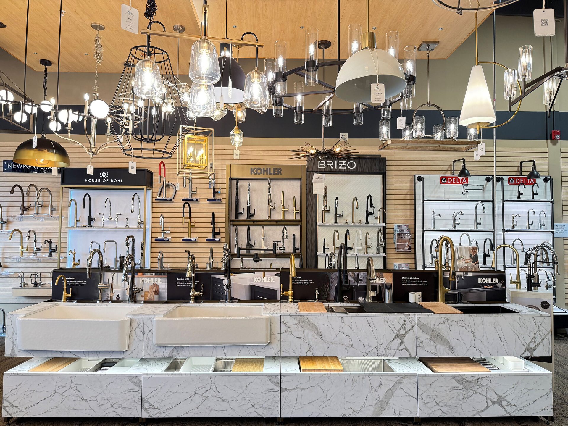 Retail display of lighting, faucets, and sinks from Kohler, Brizo, and Delta brands.