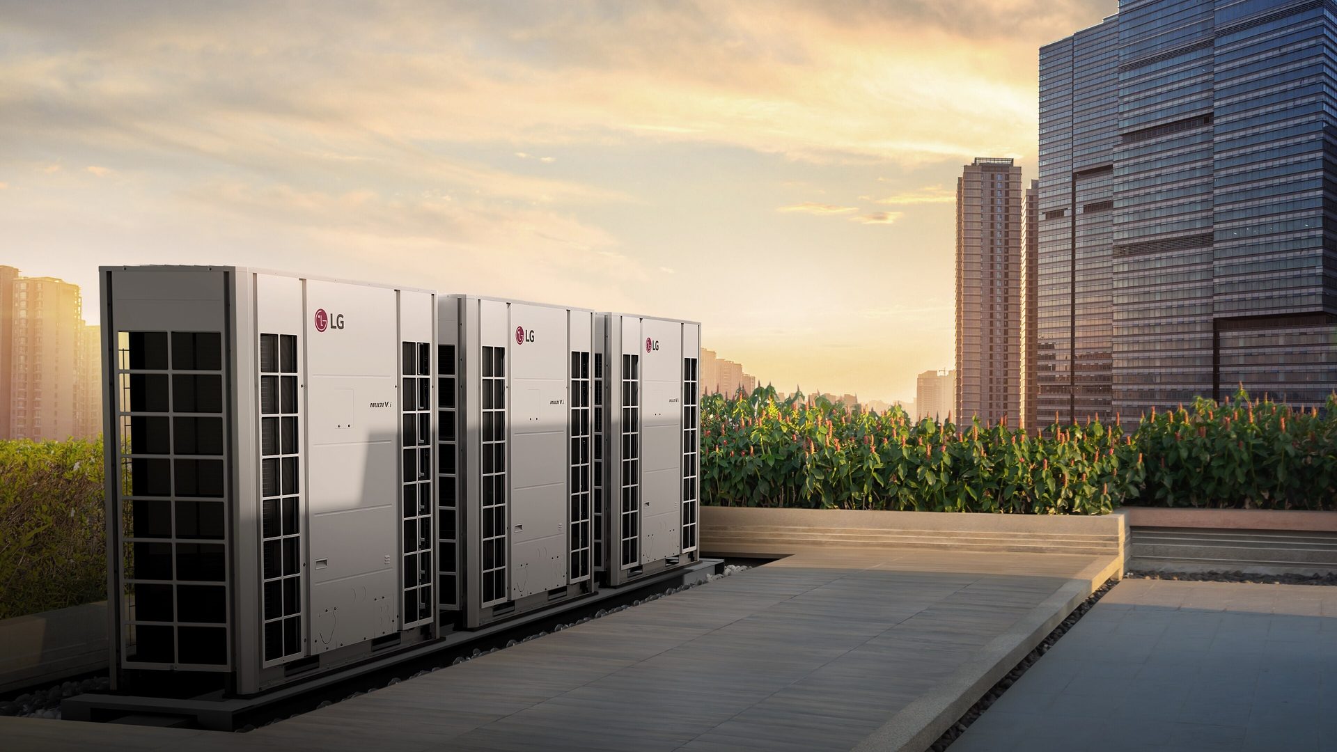 LG air conditioning units on a rooftop with a city skyline at sunset.