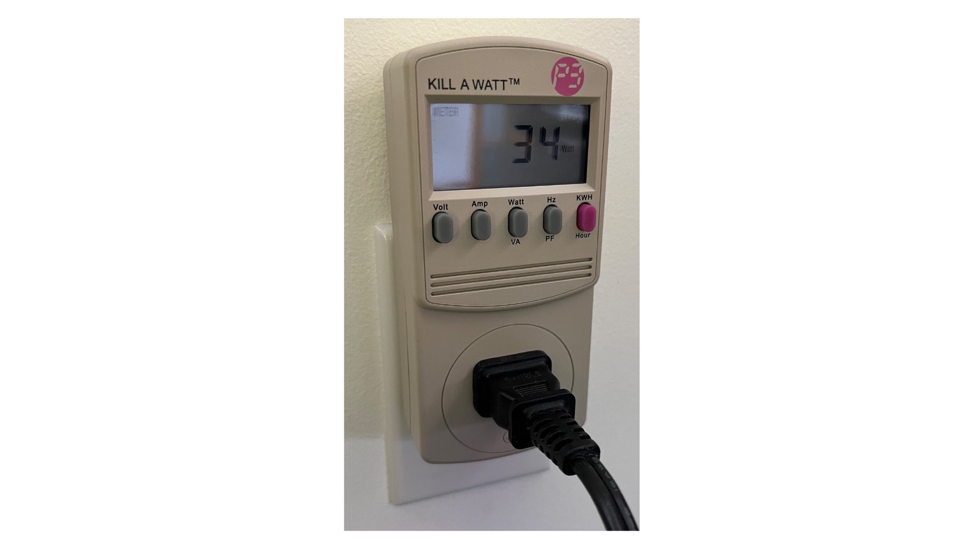 Kill A Watt meter plugged into an outlet displays "34 Watt" from a connected black plug.