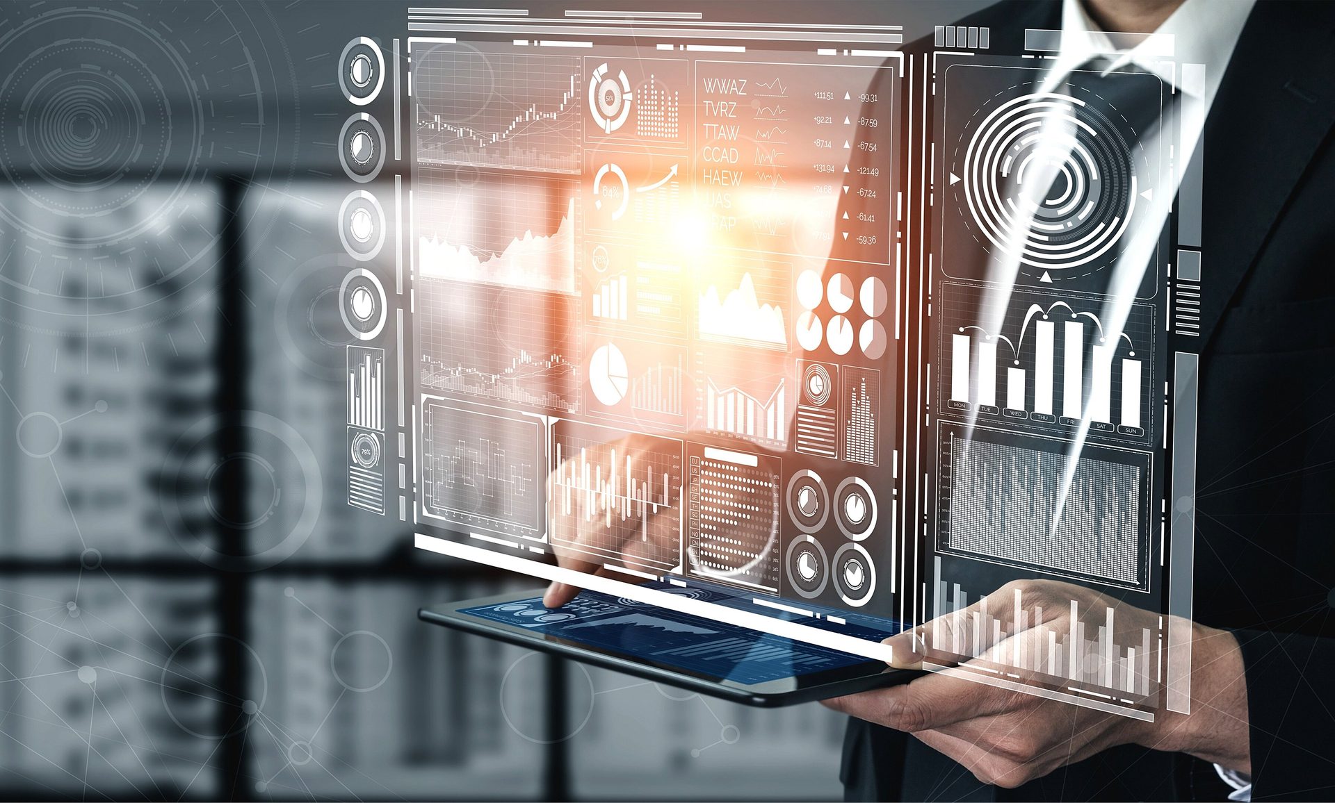A person in a suit interacts with a futuristic augmented reality display showing business data and charts.